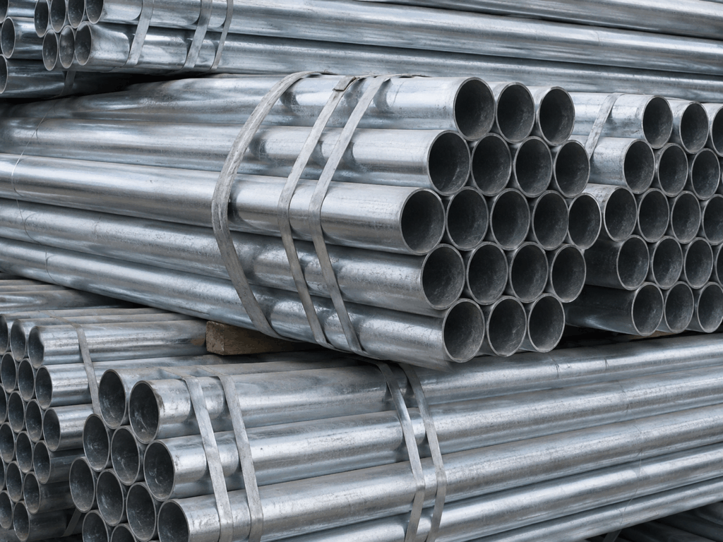 Realistic galvanized steel pipe bundles stacked in an industrial warehouse